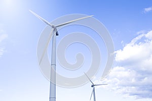 Alternative Energy Concepts. Two Windmills Outdoors Against Blue Sky