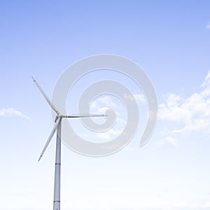 Alternative Energy Concepts. Windmill Outdoors Against Blue Sky
