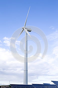 Alternative Energy Concepts. Windmill Outdoors Against Blue Sky. Vertical image