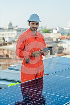 Alternative energy engineer checking energy power performace of solar power system photo