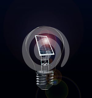 Alternative energy source. Light bulb with solar panel on background