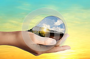 Alternative energy source. Woman holding light bulb with solar panels