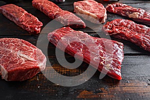 Alternative Flank bavette or flap steak beef t steak near tri-tip and top blade oyster cuts close up in front of other cuts in