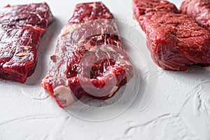 Alternative machete fajita steak organic meat cut side view close up over white concrete background