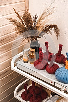 Alternative Medicine. Churna pinda sweda cotton bags filled with a mixture of herbs on table vertical close-up