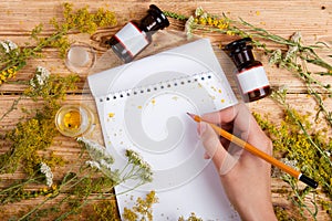 Alternative medicine concept - hand write a recipe in notepad on