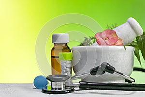 Alternative medicine concept Ã¢â¬â Homeopathic Healing herbs with a mortar and pestle with Stethoscope along with bottle of pills
