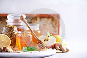 Alternative medicine concept. Ingredients for flu fighting natural hot drink. Copy space. Lemon, ginger, mint, honey, apple and