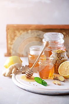 Alternative medicine concept. Ingredients for flu fighting natural hot drink. Copy space. Lemon, ginger, mint, honey, apple and