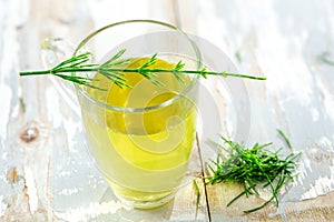 Alternative Medicine. Herbal Therapy. Horsetail infusion in glass cup. grey background