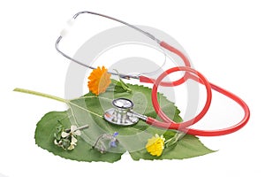 Alternative medicine herbs and stethoscope on leaf