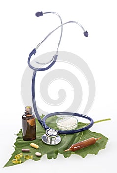 Alternative medicine herbs and stethoscope on leaf