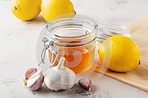 Alternative medicine, natural home remedy for cold and flu. Ginger, lemon, garlic and honey