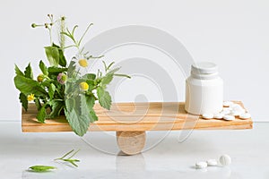 Alternative medicine or pills weight balance comparison with tablets and herbs