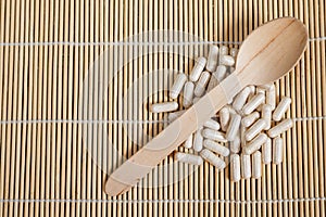 Alternative medicine tablets on a wooden spoon