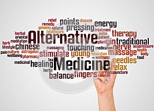 Alternative medicine word cloud and hand with marker concept