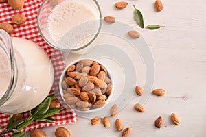 Alternative milk of almonds on white table top view