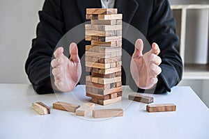 Alternative Risk and Strategy in business, Business woman`s hands protect balance wooden stack with hand control risk shape