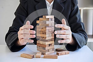 Alternative Risk and Strategy in business, Business woman`s hands protect balance wooden stack with hand control risk shape