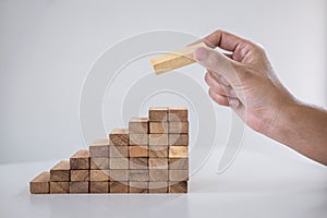 Alternative Risk and Strategy in business to make growth, Image of Business man`s hand placing making a wooden block stacking