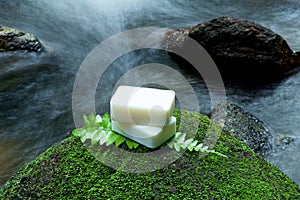 Alternative skin care homemade soap on stone, green leaf with tr