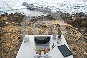 Alternative unusual happy destop technology business workstation with ocean view - digital nomad concept lifestyle for modern