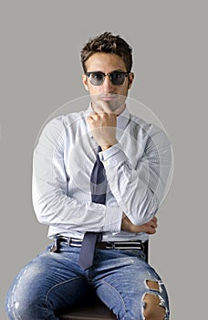 Alternative young business man wearing shirt, tie and ripped jeans
