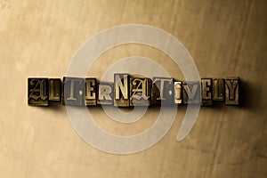 ALTERNATIVELY - close-up of grungy vintage typeset word on metal backdrop photo