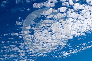 Altocumulus clouds in blue sky on sunny peaceful day