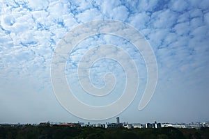 Altocumulus, Sunlight penetrating clouds, Beautiful clouds over the city. Blue background. Abstract background