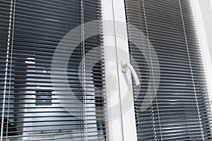 Aluminium blinds on the plastik window