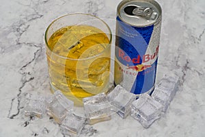 Aluminium can of Red Bull Energy drink with ice and drops, Vodka Absolut. Red Bull is the most popular energy drink in the world.