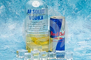 Aluminium can of Red Bull Energy drink with ice and drops, Vodka Absolut. Red Bull is the most popular energy drink in the world.