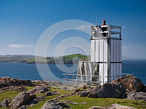 The aluminium clad tower and solar panels of solar powered Muckle Roe Lighthouse at Swarbacks Minn on Shetland, UK