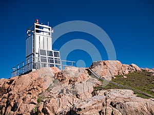 The aluminium clad tower and solar panels of solar powered Muckle Roe Lighthouse at Swarbacks Minn on Shetland, UK