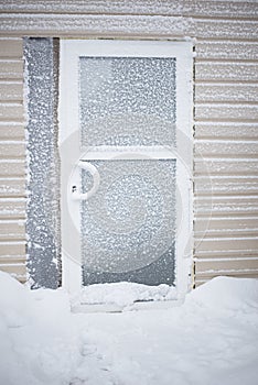 Aluminium glass door covered with snow