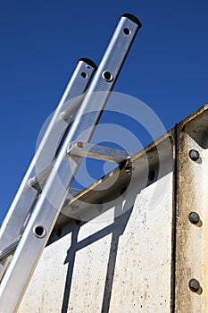 Aluminium ladder securely fastened at top