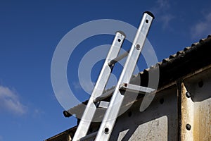 Aluminium ladder securely fastened at top