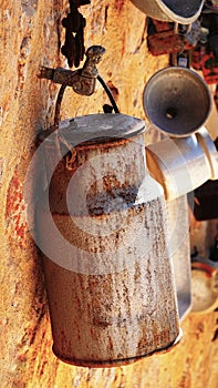 Aluminium milk can Hanging on the Wall. Grunge Rusty Milk Churn