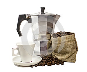 Aluminium moka pota, white ceramic coffee cup and burlap sack overflowing with roasted coffee beans in white background.