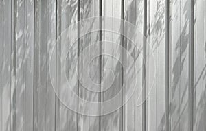 Aluminium wall with tree shadows texture background