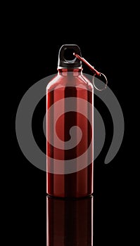 Aluminium water flask on reflective black surface