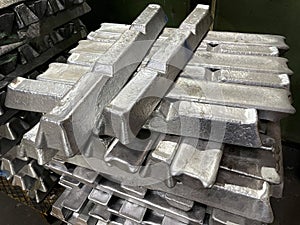 Aluminum alloy ingots stacked in the foreground