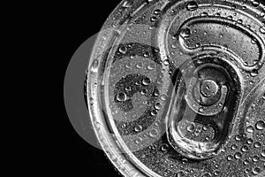 Aluminum can of beverage covered with water drops on black background. Space for text