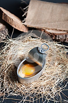 Aluminum can with egg yolk inside insulated on black background