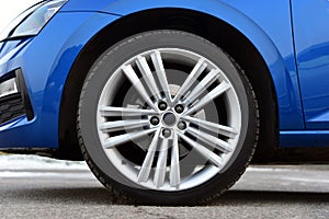Aluminum car wheel with a tire on a sports car