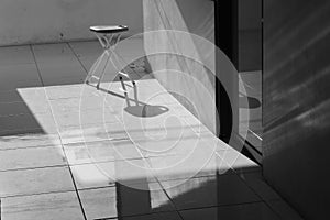 Aluminum chairs in black and white with harsh shadows. Loneliness and the concept of alienation