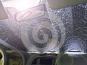 Aluminum coverlet on the windshield of the car to protect from heat and sun inside.