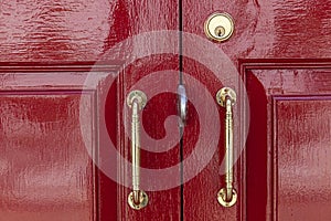 aluminum door handle and red wood door