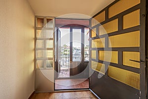 Aluminum doors with translucent glass with an antechamber with doors of the same material with access to a terrace photo